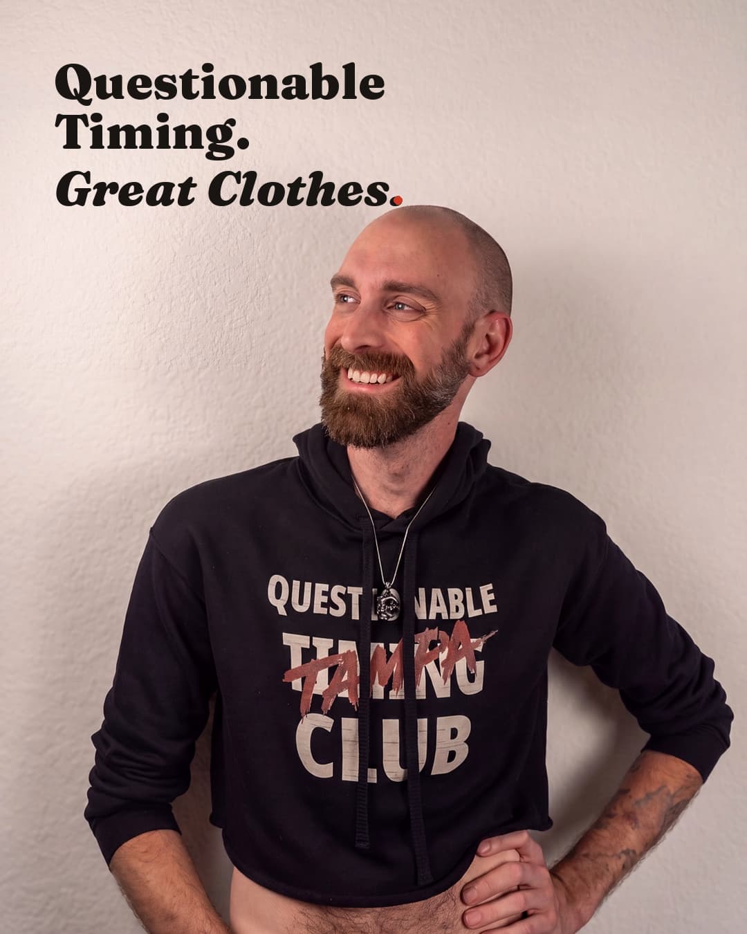 Josh, founder of Questionable Timing Club, wearing a black cropped QTC hoodie